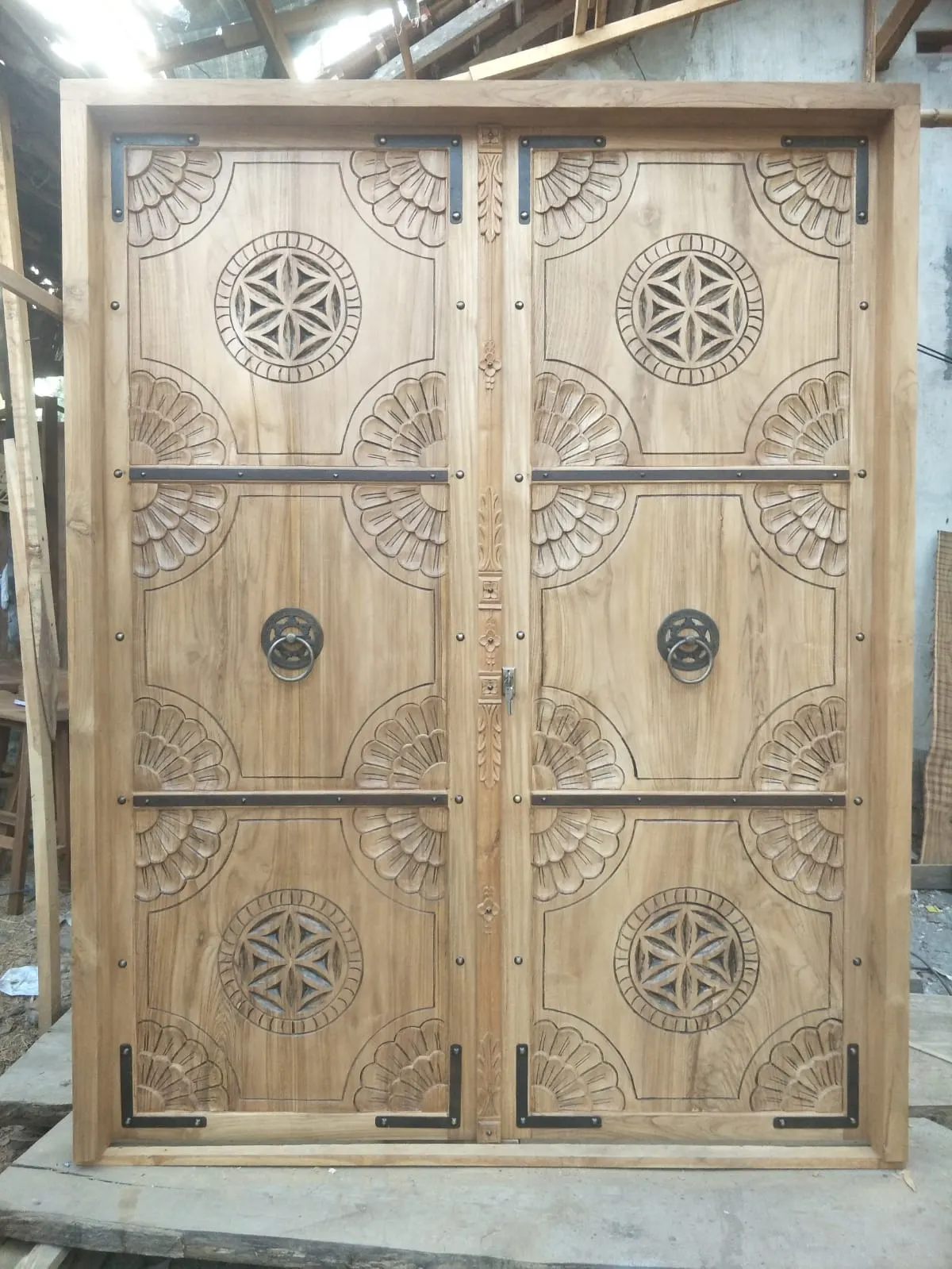 Grande double porte en teck à rosaces et heurtoirs
